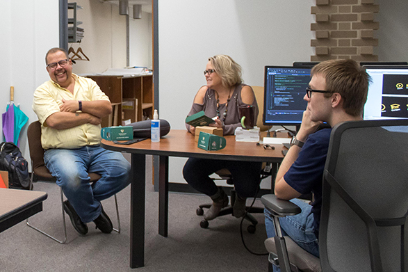 Gary Cendrowski (left), Melissa Crabtree and Eric Chapiewski discuss the new Wayne State Virtual Experience app in the VR workspace at Computing, Friday, Sept. 21, 2018. 